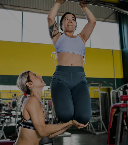 Personal trainer demonstrating exercises in a gym setting in Columbus, Ohio.